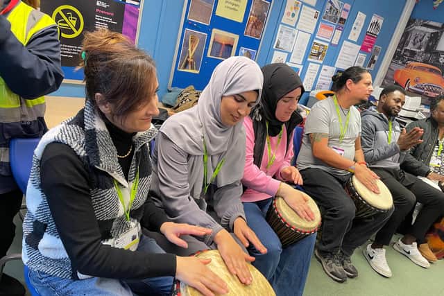 ESOL students enjoying the drumming session at City of Portsmouth College.