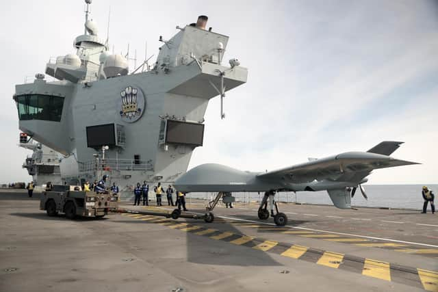 Pictured: Mojave aircraft is taken back into the hanger after a successful trail on HMS Prince of Wales. 

Pic: RN