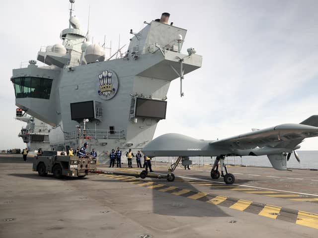 Pictured: Mojave aircraft is taken back into the hanger after a successful trail on HMS Prince of Wales. 

Pic: RN
