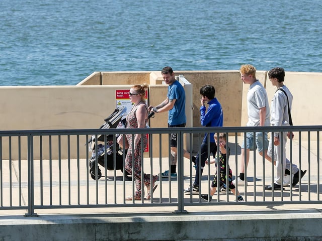 Walkers on Long Curtain Moat, Old Portsmouth. Picture: Chris Moorhouse (250524-10)