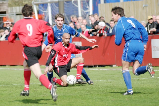 Martin Carruthers is put under pressure by Matlock Town's James Lukic.