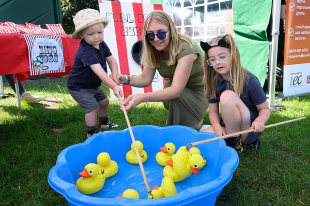 Dalton, Emily and Matilda Thomas fish for ducks at Party in the Park.Picture: Keith Woodland (270721-3)