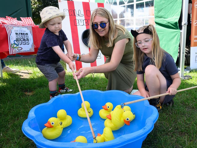 Dalton, Emily and Matilda Thomas fish for ducks at Party in the Park.Picture: Keith Woodland (270721-3)