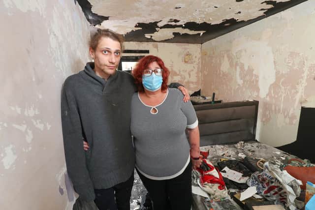 Eve Rendle and her son Michael pictured in their fire damaged home. The are appealing to the community for help in repairing the property as they did not have home insurance. The pair are pictured in Eve's bedroom. Picture: Stuart Martin (220421-7042)