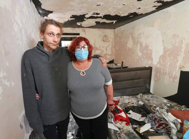 Eve Rendle and her son Michael pictured in their fire damaged home. The are appealing to the community for help in repairing the property as they did not have home insurance. The pair are pictured in Eve's bedroom. Picture: Stuart Martin (220421-7042)