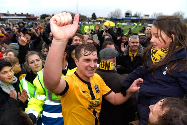 Jamie Collins celebrates with Sutton United fans after the FA Cup Fourth Round win against Leeds. Photo by Mike Hewitt/Getty Images.