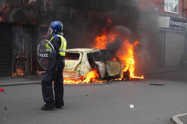A car burns on Parliament Road, in Middlesbrough, during an anti-immigration riot. Credit: Owen Humphreys/PA Wire