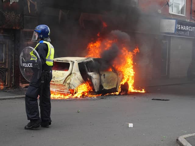 A car burns on Parliament Road, in Middlesbrough, during an anti-immigration riot. Credit: Owen Humphreys/PA Wire