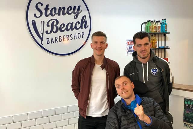 Jack Farrugia with Pompey players Paul Downing and John Marquis at Stoney Beach Barbershop, Marmion Road, Southsea, which is owned by his brother, Joe