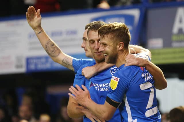 Michael Jacobs is mobbed by his team-mates after his 63rd-minute equaliser