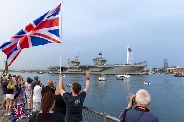 Well-wishers watching HMS Queen Elizabeth leave Portsmouth ahead of her deployment in the Norwegian Sea.