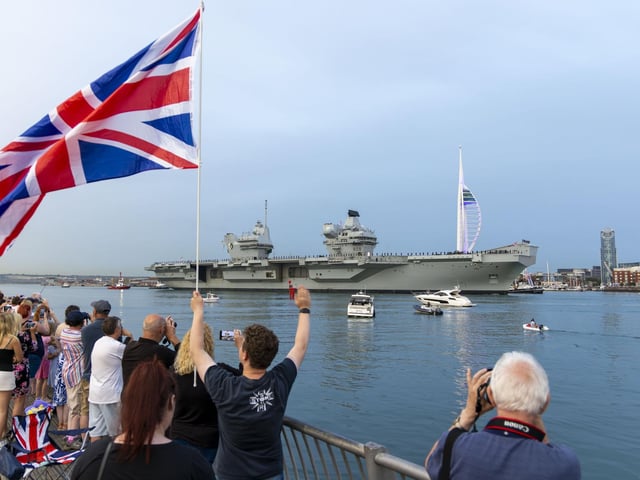 Well-wishers watching HMS Queen Elizabeth leave Portsmouth ahead of her deployment in the Norwegian Sea.