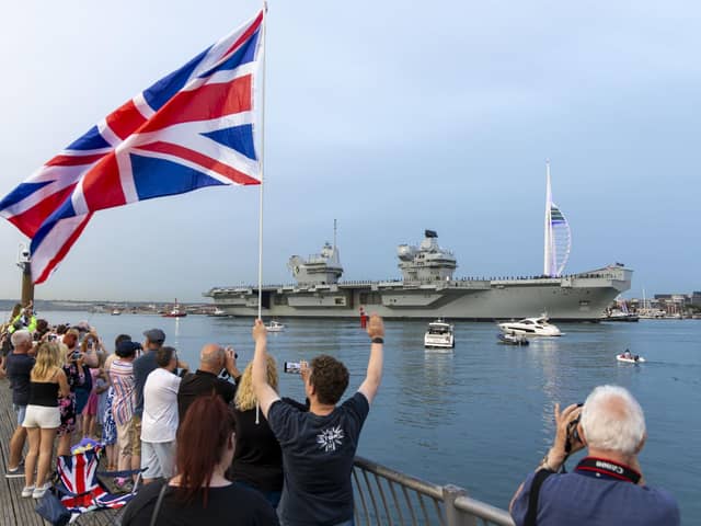 Well-wishers watching HMS Queen Elizabeth leave Portsmouth ahead of her deployment in the Norwegian Sea.