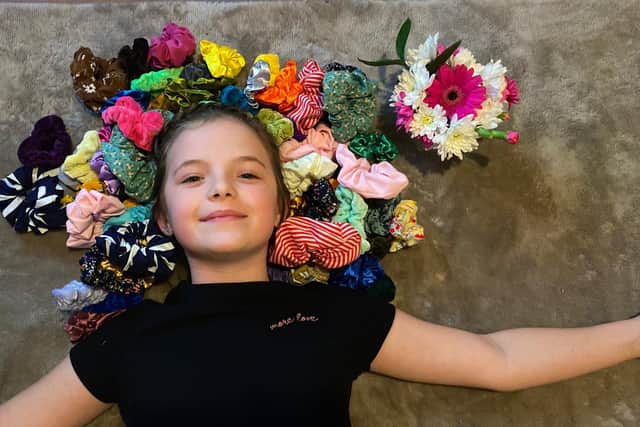 Isabelle Smith, 9 from Havant, has been making and selling scrunchies and raised funds for Children in Need. Pictured: Isabelle with a selection of her scrunchie creations