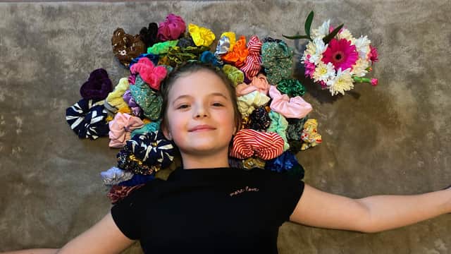 Isabelle Smith, 9 from Havant, has been making and selling scrunchies and raised funds for Children in Need. Pictured: Isabelle with a selection of her scrunchie creations