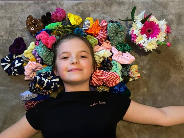 Isabelle Smith, 9 from Havant, has been making and selling scrunchies and raised funds for Children in Need. Pictured: Isabelle with a selection of her scrunchie creations