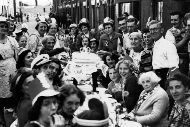 A coronation party, 1953 in Seymour Street, Buckland. Elizabeth Johnson cutting the cake
