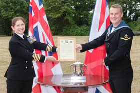 Leading Aircraft Controller Jack Stait, 25, is presented with the first ever Royal Navy Air Traffic Management Commodore’s Cup, from the commandingoOfficer of HMS Collingwood, Captain Catherine Jordan at the base's wardroom. Photo: Keith Woodland/Royal Navy