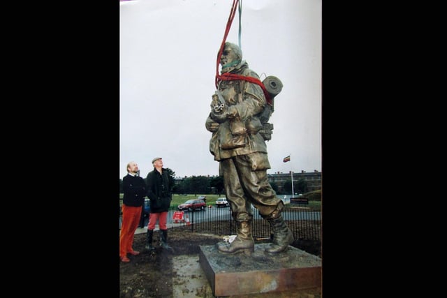 The Yomper staue being erected at the entrance to the Royal Marines Museum at Eastney, being inspected by sculptor Philip Jackson (left) and Colonel Keith Wilkins director of the museum 5th July 1992.