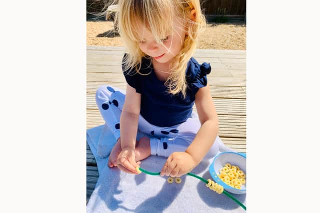 Harper Gibney, two, has raised hundreds of pounds for a coronavirus support group, Hayling Helpers, by making bird feeders.