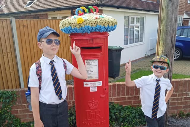 Thomas Smith, nine, and Noah Smith, five, with the postbox on the corner of Parkside and Queen Anne's Drive