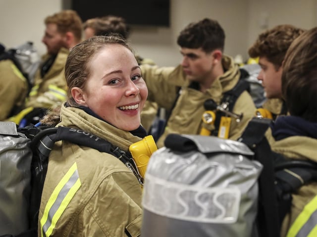 The support party muster for a re-entry brief as part of a fire exercise on HMS Queen Elizabeth