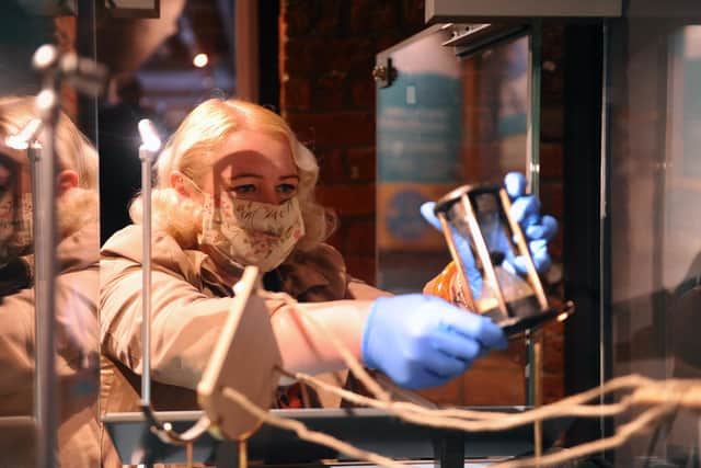 The National Museum of the Royal Navy has opened its first new exhibition since the start of the coronavirus pandemic, focusing on the doomed "Ferrari" of the Royal Navy, HMS Invincible. The display, called Diving Deep: HMS Invincible 1744 tells the tale of how the ship sank in the Solent and the effort to help recover lost artefacts from it.
Pictured is: Alice Roberts-Pratt, curator (exhibitions).
Picture: Sarah Standing (221020-6236)