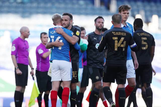 The Pompey players congratulate Wigan at the final whistle at Fratton Park.