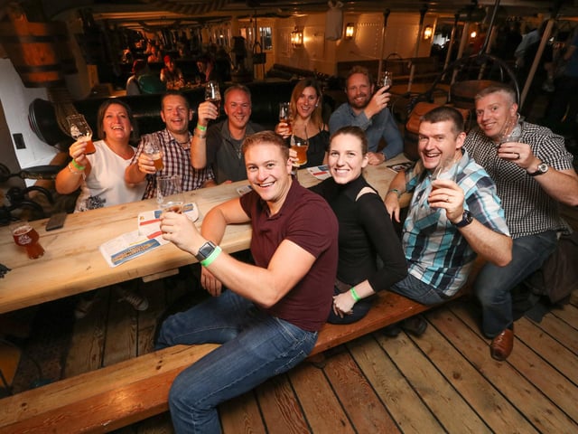 HMS Warrior, Historic Dockyard 2017. Beer festival on HMS Warrior - Warriorfest, the first run there by Staggeringly Good brewery in Fratton. Friends having a drink. Photography by Habibur Rahman
