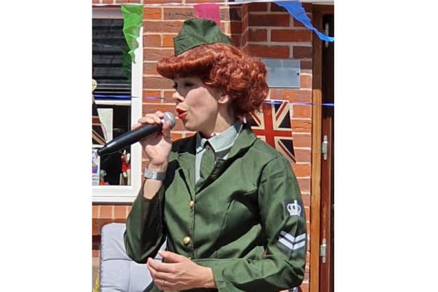 Helen Wallis has been raising money throughout lockdown for Queen Alexanda Hospital by offering her performing arts classes online and people could give a small donation, as well as performing on her drive during VE Day. Pictured: Helen performing on VE Day