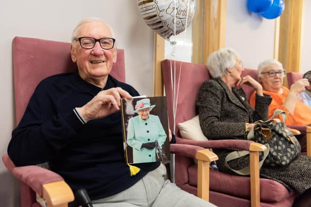 Douglas with his birthday greeting from The Queen. Picture: Duncan Shepherd
