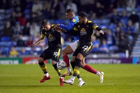 Gassan Ahadme battles for the ball with Sutton United's Harry Beautyman (left) and Joe Kizzi (right) in the Papa John's Trophy. Picture: Adam Davy/PA Wire.