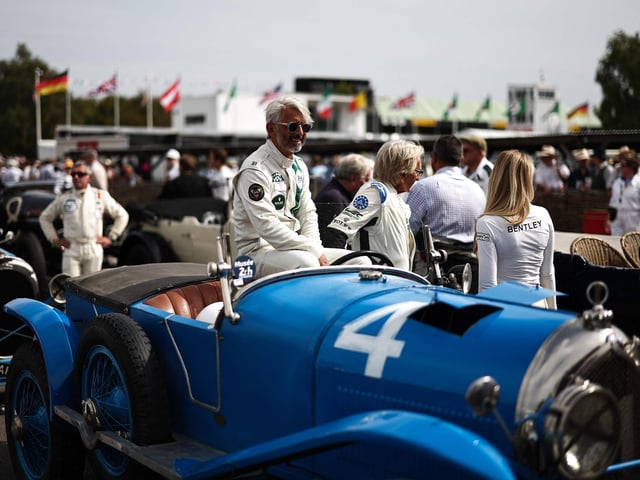 Drivers sit in classic cars as they follow a race during the opening day of Goodwood Revival at the Goodwood Motor Circuit in Chichester on September 8, 2023. The only historic motor race meeting to be staged entirely in a period theme, Goodwood Revival is an immersive celebration of iconic cars and fashion. (Photo by HENRY NICHOLLS / AFP)  (Photo by HENRY NICHOLLS/AFP via Getty Images)