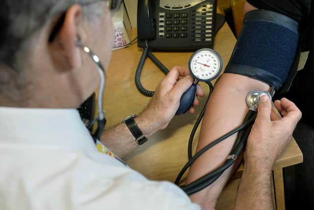 A GP checking a patient's blood pressure Picture: PA