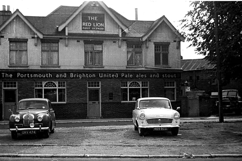 Austin Somerset and Standard Vanguard cars standing sentry at The Red Lion public house in Omega Street, Landport. Did you own one of the cars?
