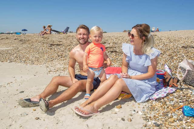 Ali and Alice Whitehouse with Franklin, 18 months, on Eastern Parade beach. Picture: Habibur Rahman