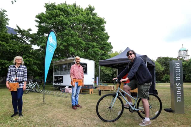 The News' Chris Broom tries out Rider Spoke in Victoria Park, Portsmouth, with the help of Ausra Vaisvilaite, left, and Leo Lami
Picture: Chris Moorhouse
