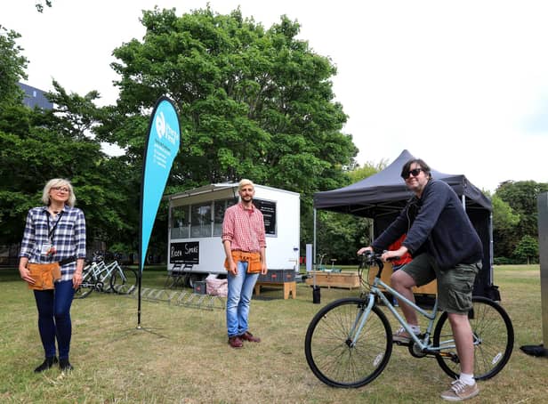 The News' Chris Broom tries out Rider Spoke in Victoria Park, Portsmouth, with the help of Ausra Vaisvilaite, left, and Leo Lami
Picture: Chris Moorhouse