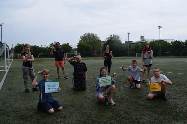 Priory School headteacher, Stewart Vaughan along with pastoral outreach worker, Katherine Hughes, and the key worker children who took part in the run.