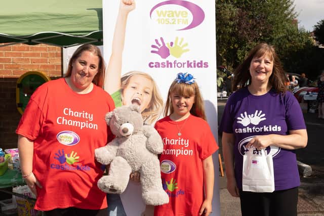 Sarah and Grace McElhinney with Judith Meagher from Wave 105 Cash for Kids. Picture: Keith Woodland (260921-6)