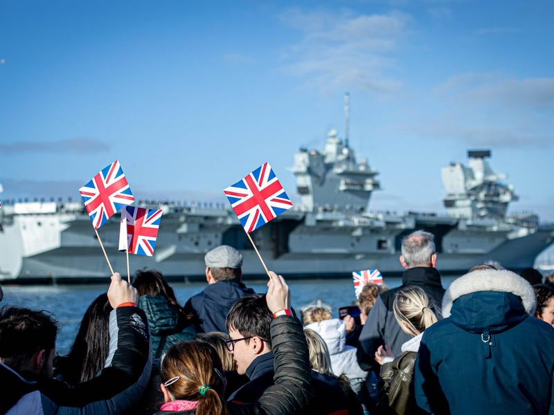 Pictured: Families gathering at Portsmouth Naval Base to see HMS Prince of Wales return home after a three month deployment in the USA. The Queen Elizabeth-class carrier completed her first long-term mission after being beset with mechanical problems last year.