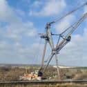 A large crane usually moored near Tipner broke free during high winds and was blown to the other side of the water, resting perilously close to the M275. Photos by Alex Shute
