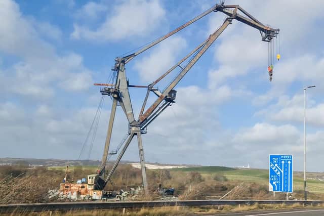 A large crane usually moored near Tipner broke free during high winds and was blown to the other side of the water, resting perilously close to the M275. Photos by Alex Shute