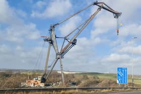 A large crane usually moored near Tipner broke free during high winds and was blown to the other side of the water, resting perilously close to the M275. Photos by Alex Shute