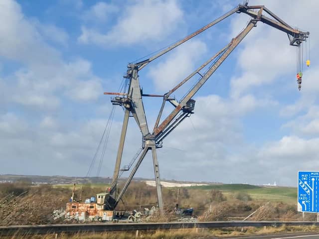A large crane usually moored near Tipner broke free during high winds and was blown to the other side of the water, resting perilously close to the M275. Photos by Alex Shute