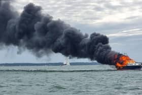 Two people were rescued off a burning boat in Portsmouth harbour on June 19. Pic GAFIRS