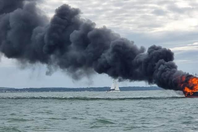 Two people were rescued off a burning boat in Portsmouth harbour on June 19. Pic GAFIRS