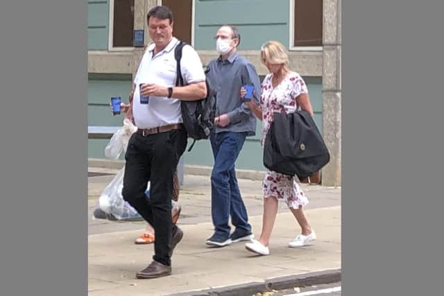 Office worker Mark Oliver, 56, leaves Winchester Crown Court flanked by his two sisters after he was cleared of murdering his younger brother Andrew, a 53-year-old dad-of-two and grandfather.