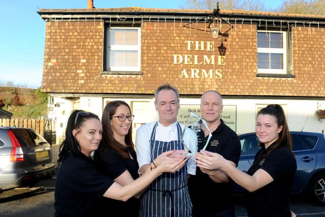 Staff at the Delme Arms with the Pub of the Year award from the The News, Portsmouth competition. 

Pictured is: (l-r) Nadine Derrick, bar staff, Sarah Eccleston, landlady, Adrian Leslie, head chef, Neil Matthews, landlord and Ruby Jermyn, bar staff.

Picture: Sarah Standing (030120-4441)