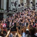 Graduates throw their mortar boards in the air during a University of Portsmouth graduation ceremony at The Guildhall, Portsmouth. Photo: Melanie Leininger (142225-18)